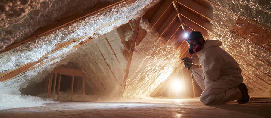 contractor sprays attic spray foam insulation